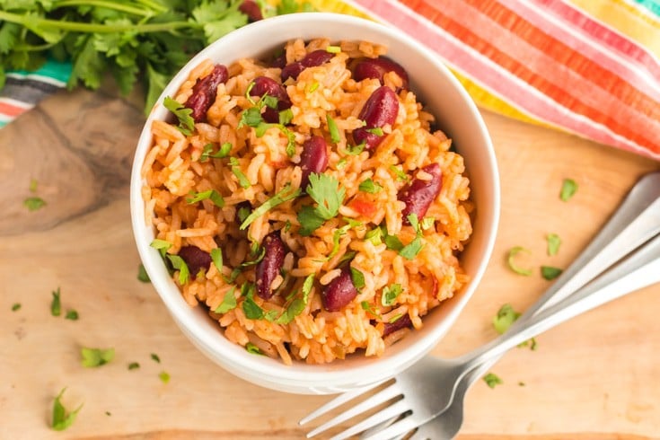 Bowl of Mexican rice and beans with a table fork.