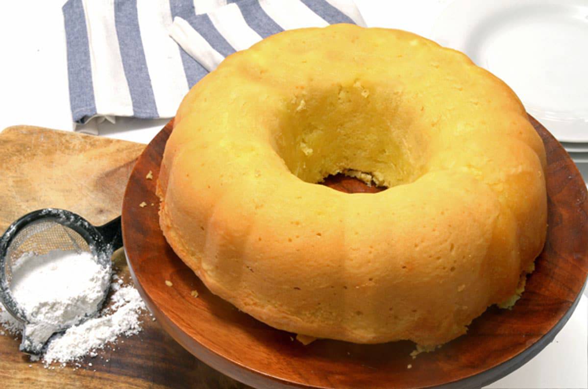 A yellow bundt cake on a platter.