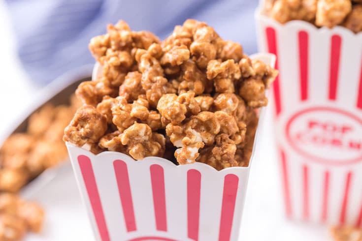 Heaping popcorn box filled with caramel popcorn.