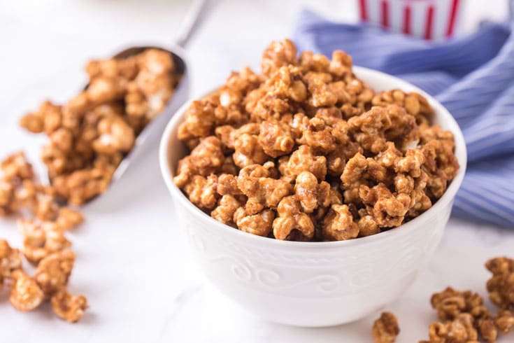 Bowl of caramel corn with a scoop.