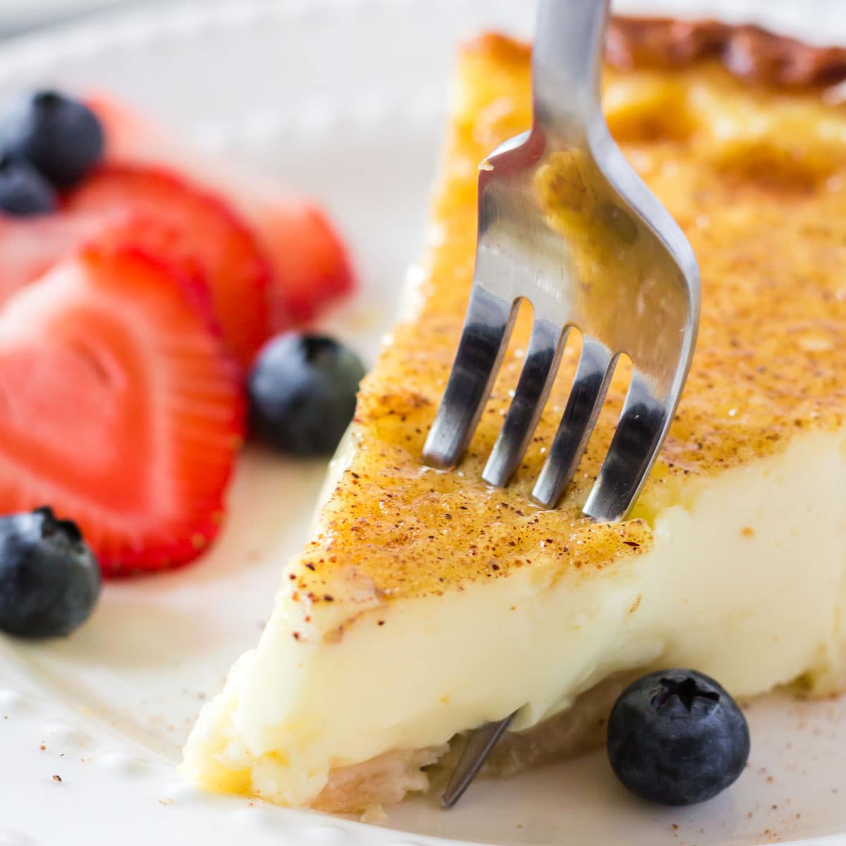 A tablefork digging into a piece of pie.