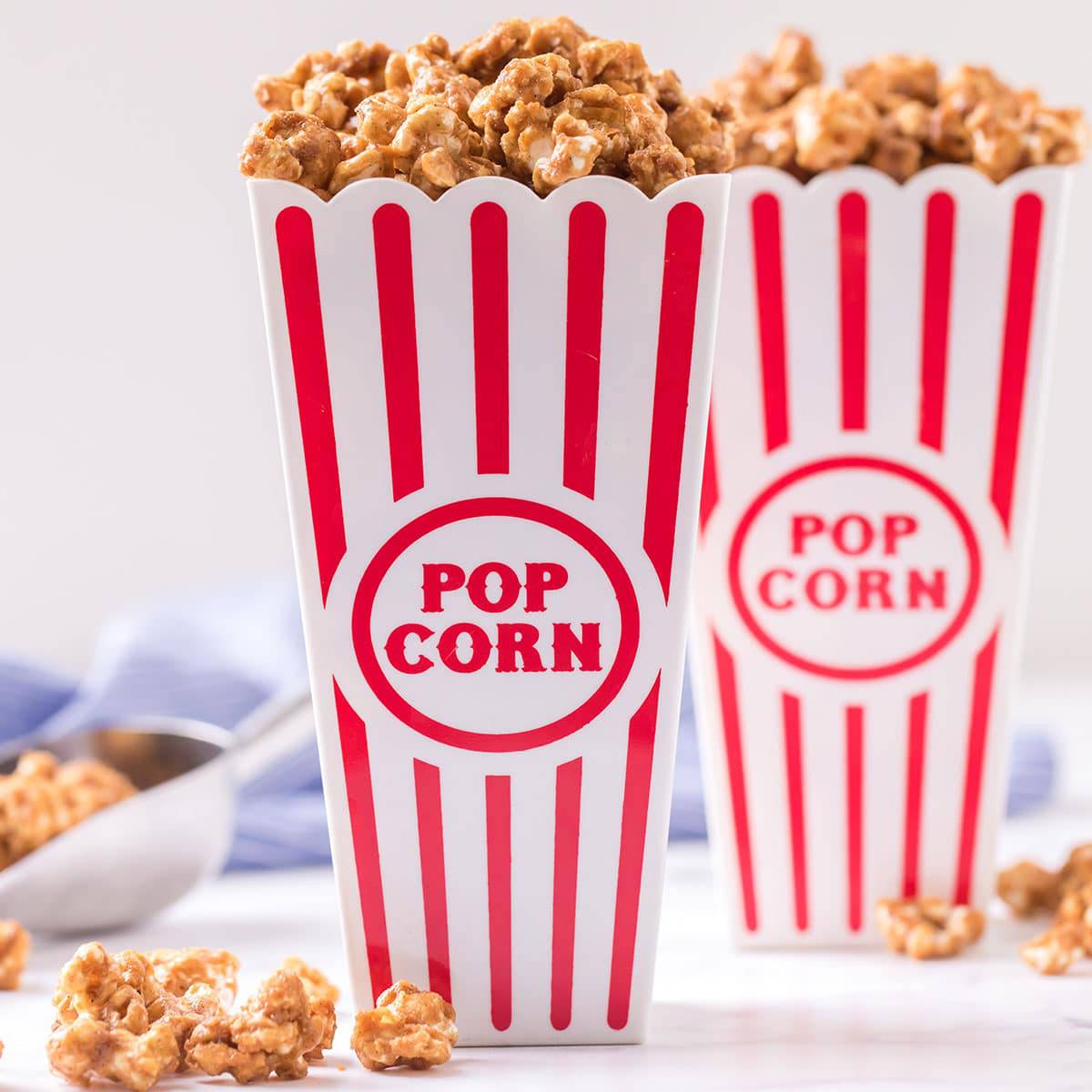 Two popcorn boxes filled with homeade caramel popcorn.