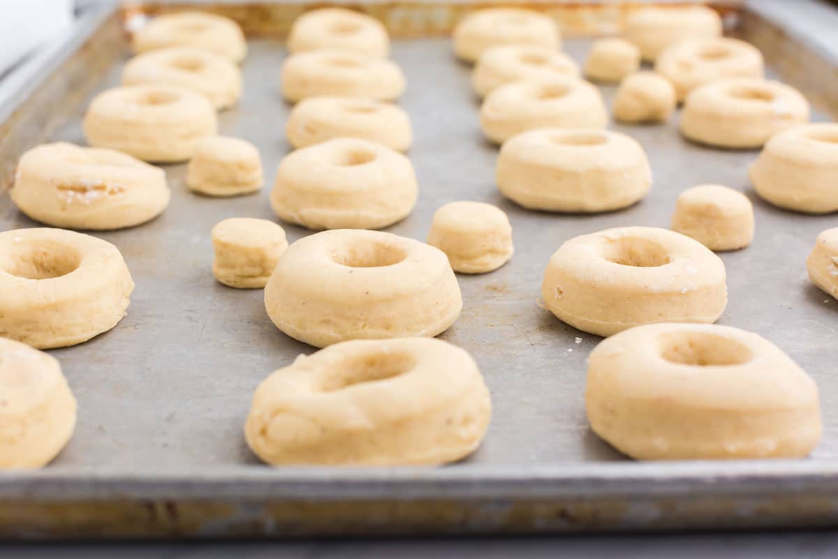 a baking sheet filled with fasnacht donuts