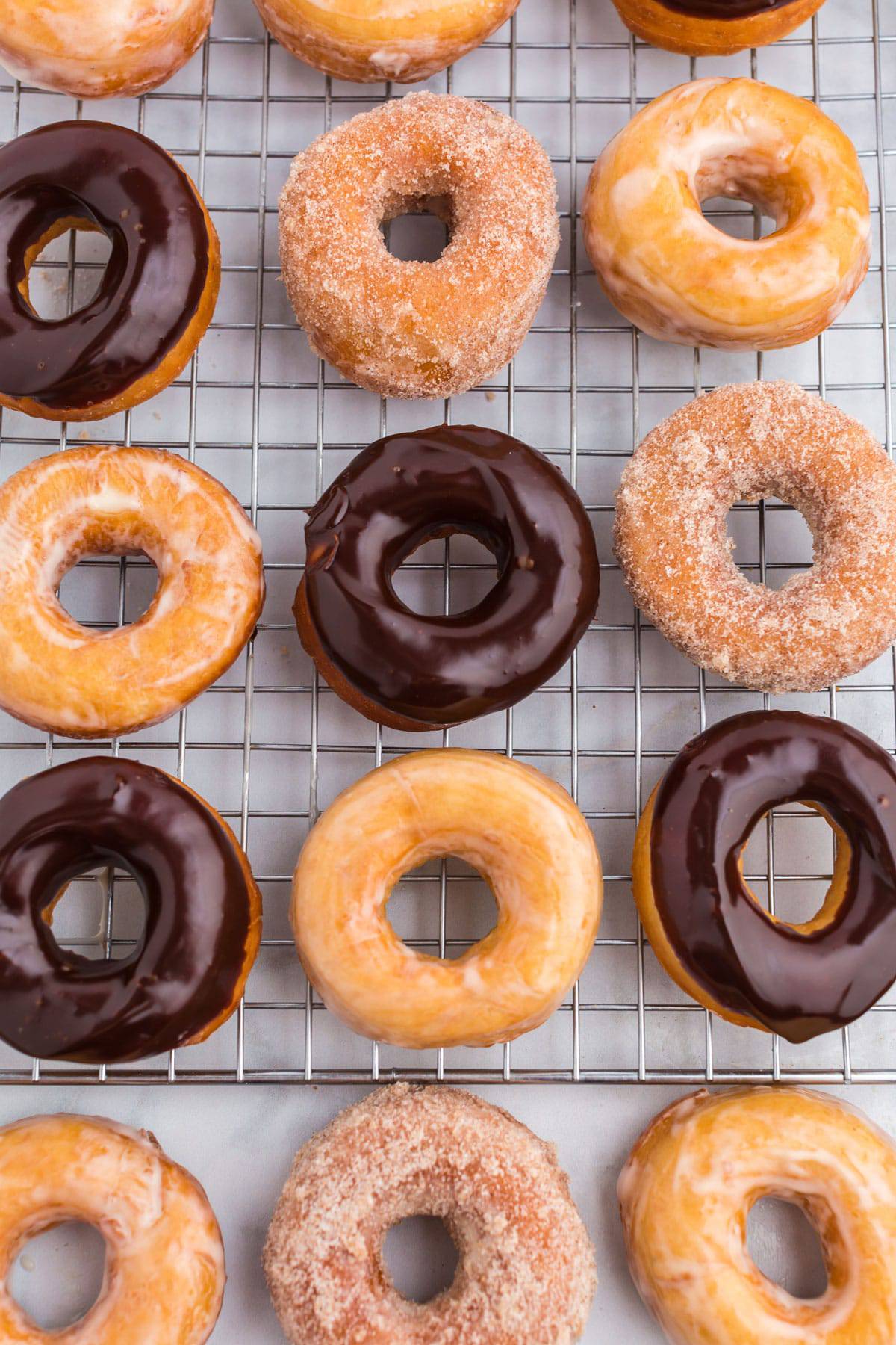 Raised donuts on a cooling rack