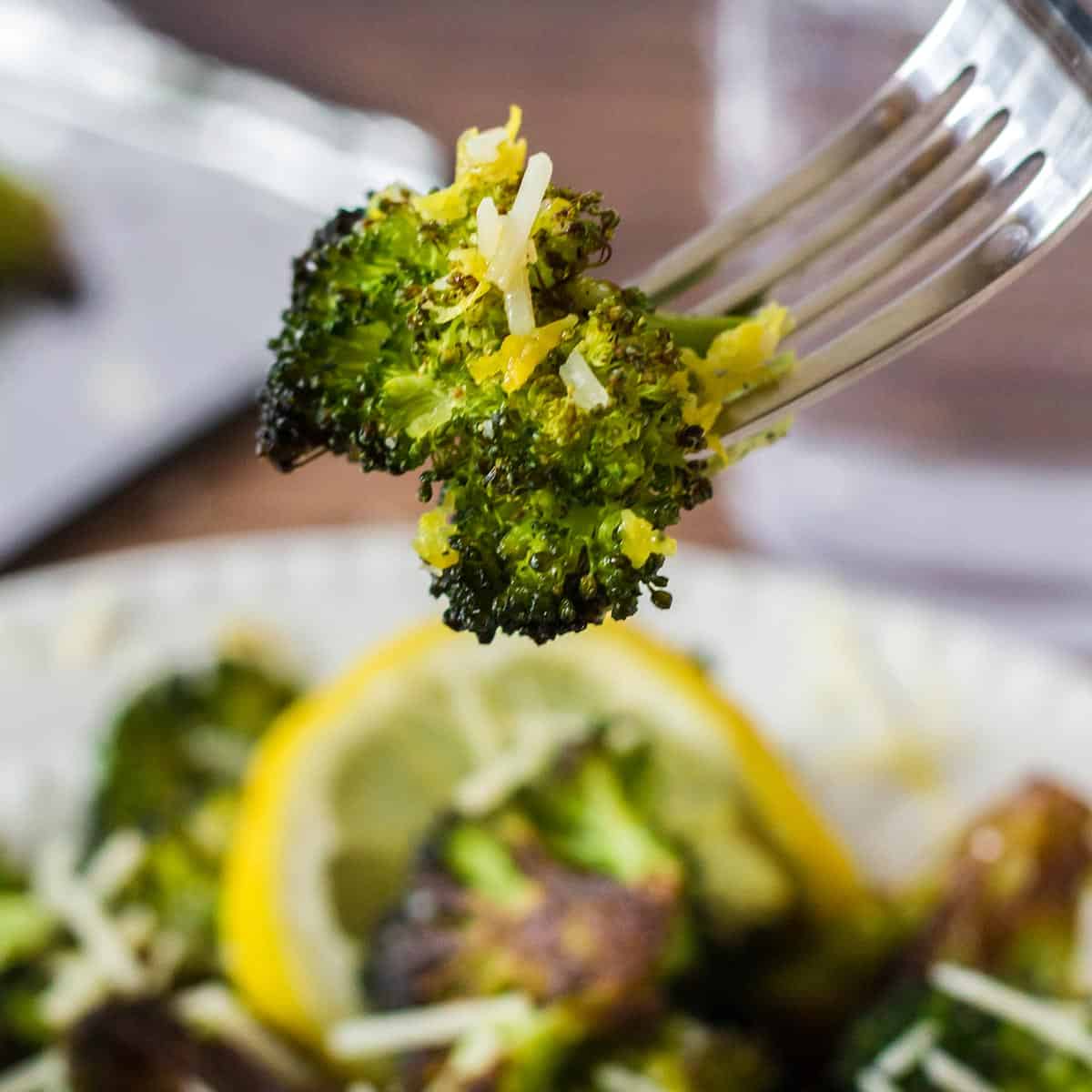 Roasted broccoli with cheese recipe A piece of broccoli on a fork.