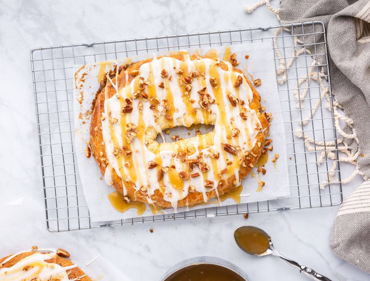 A pecan-filled Danish kringle A Danish krinlge, frosted and garnished with pecans