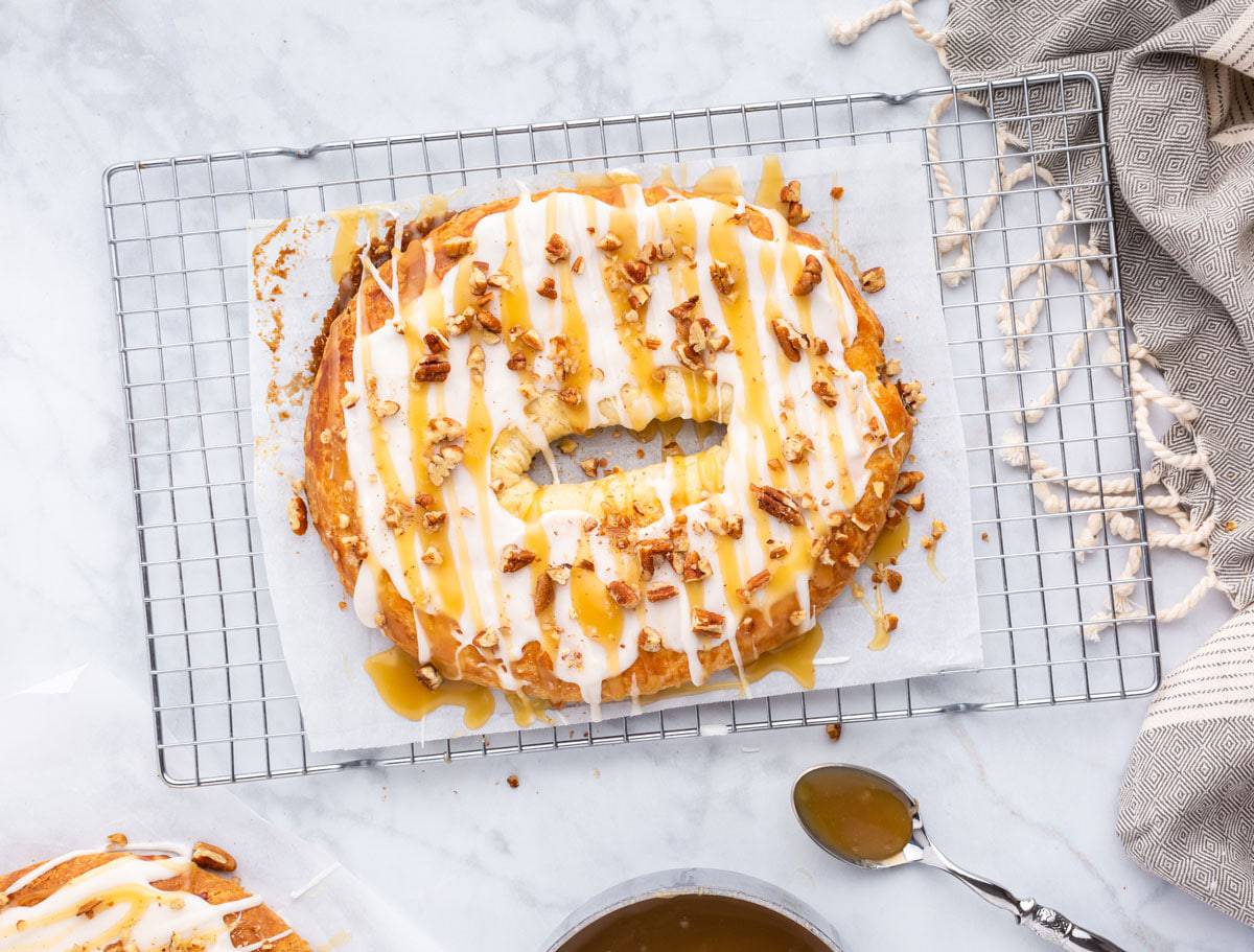 A Danish krinlge, frosted and garnished with pecans