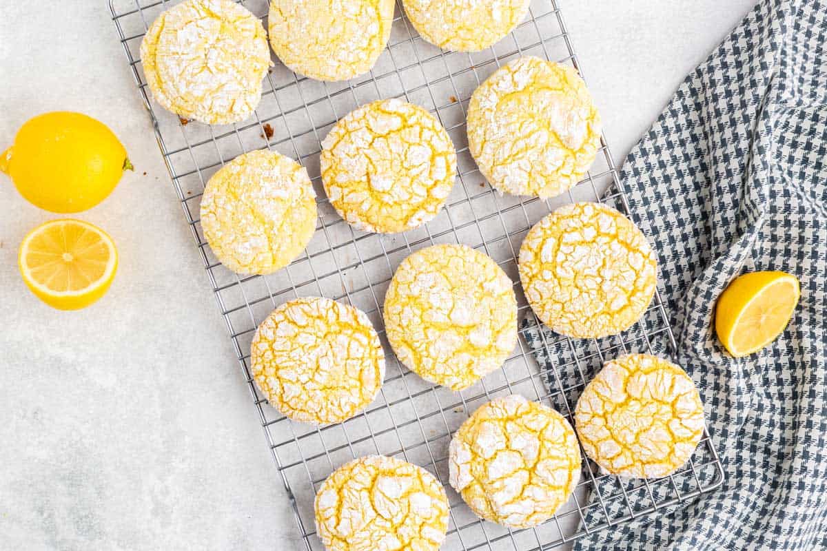 Lemon cookies cooling on a rack. A bunch of lemon cookies in a cooling rack.