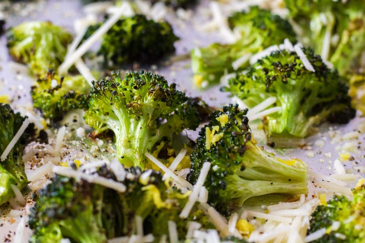 Roasted broccoli with cheese Close up of broccoli florets on a pan.