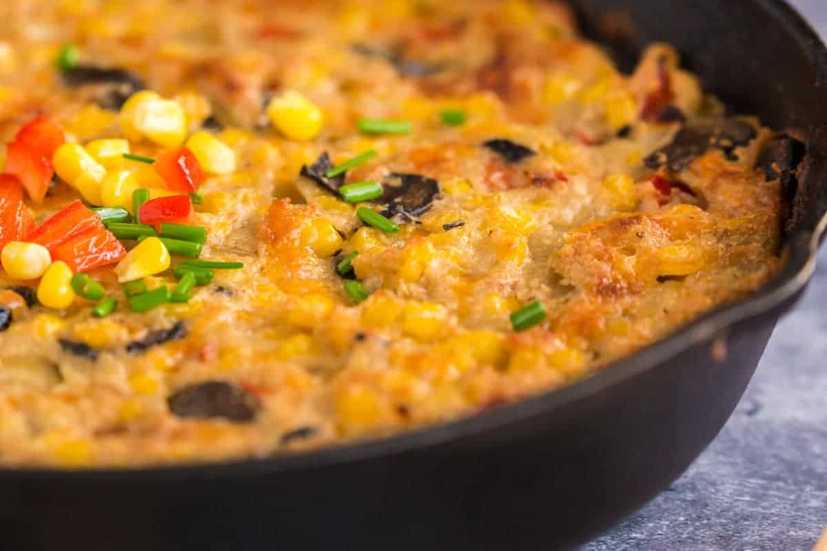 Close up of a baked corn casserole in a skillet