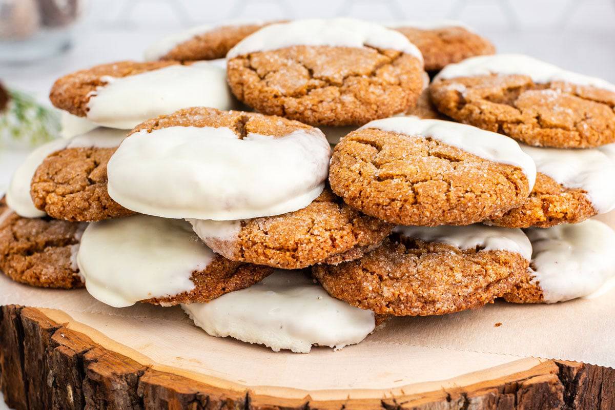 A pile of ginger cookies with white frosting A bunch of cookies with white frosting.