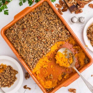 Half-eaten sweet potato souffle in a casserole dish