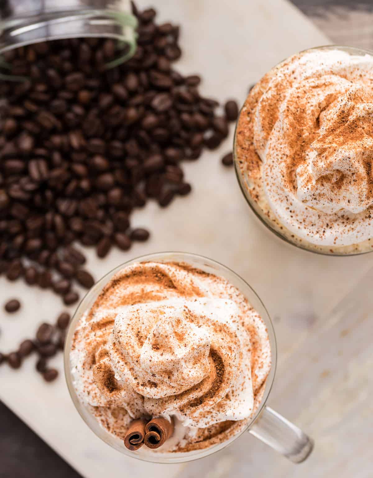 Two lattes with coffee beans