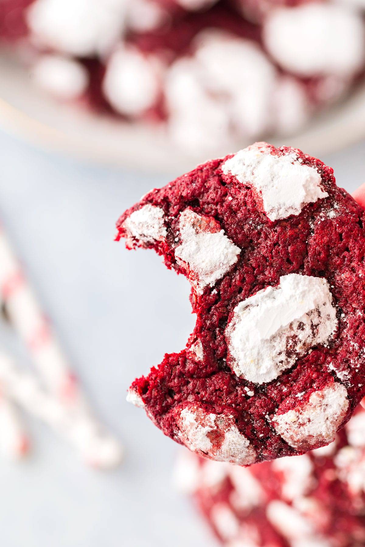 Bite out of a red velvet crinkle cookie Close up of a red cookie with a bite taken out of it