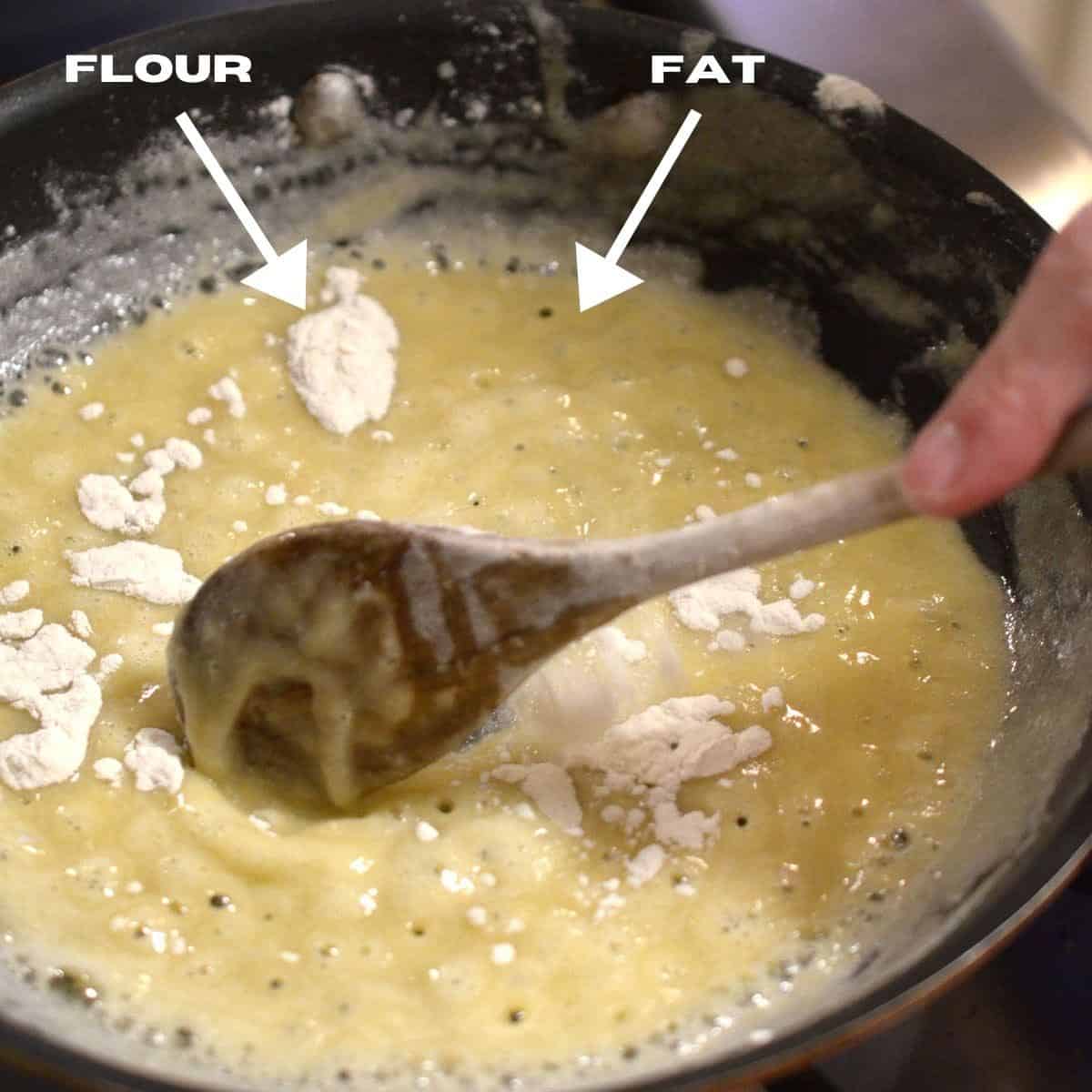 Making a roux in a skillet with flour and fat.