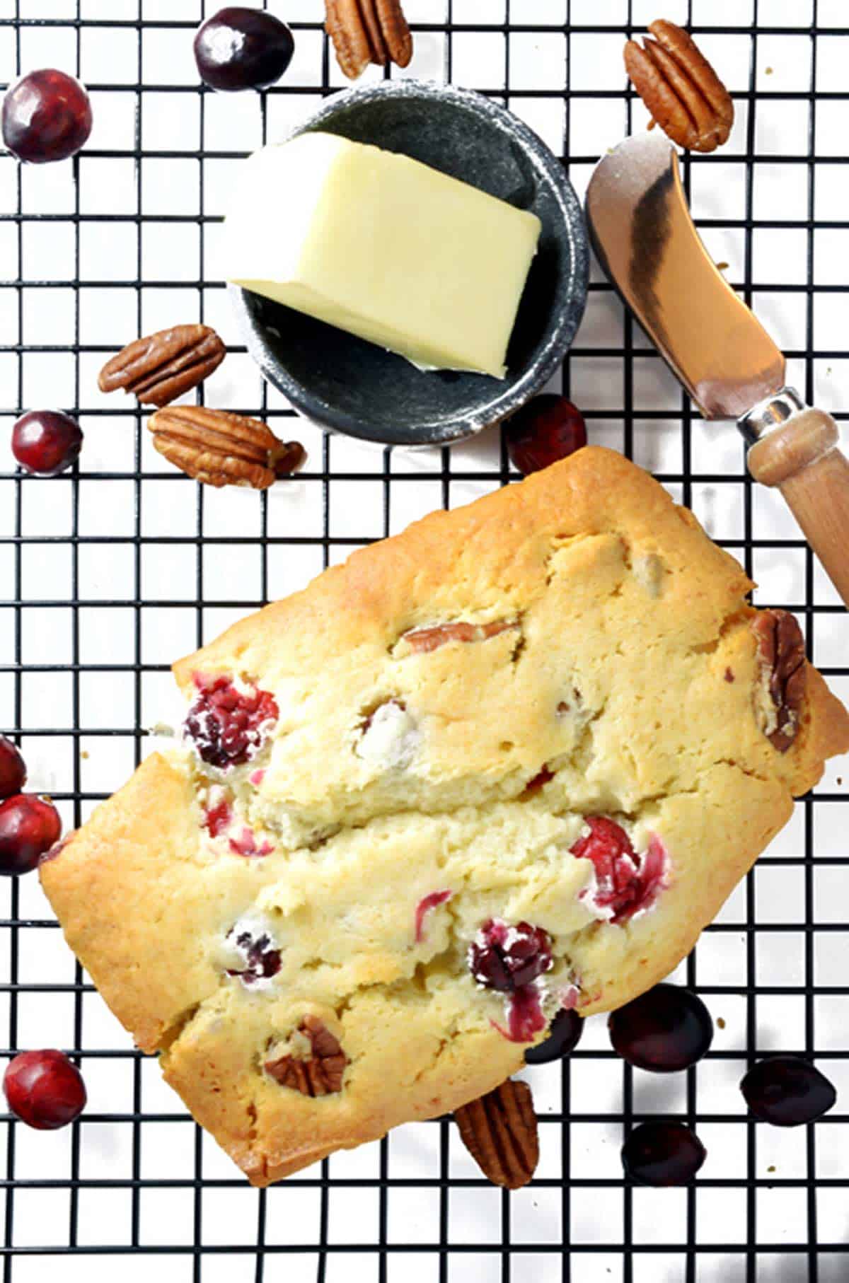 overhead view of cranberry nut bread on a cooling rack.