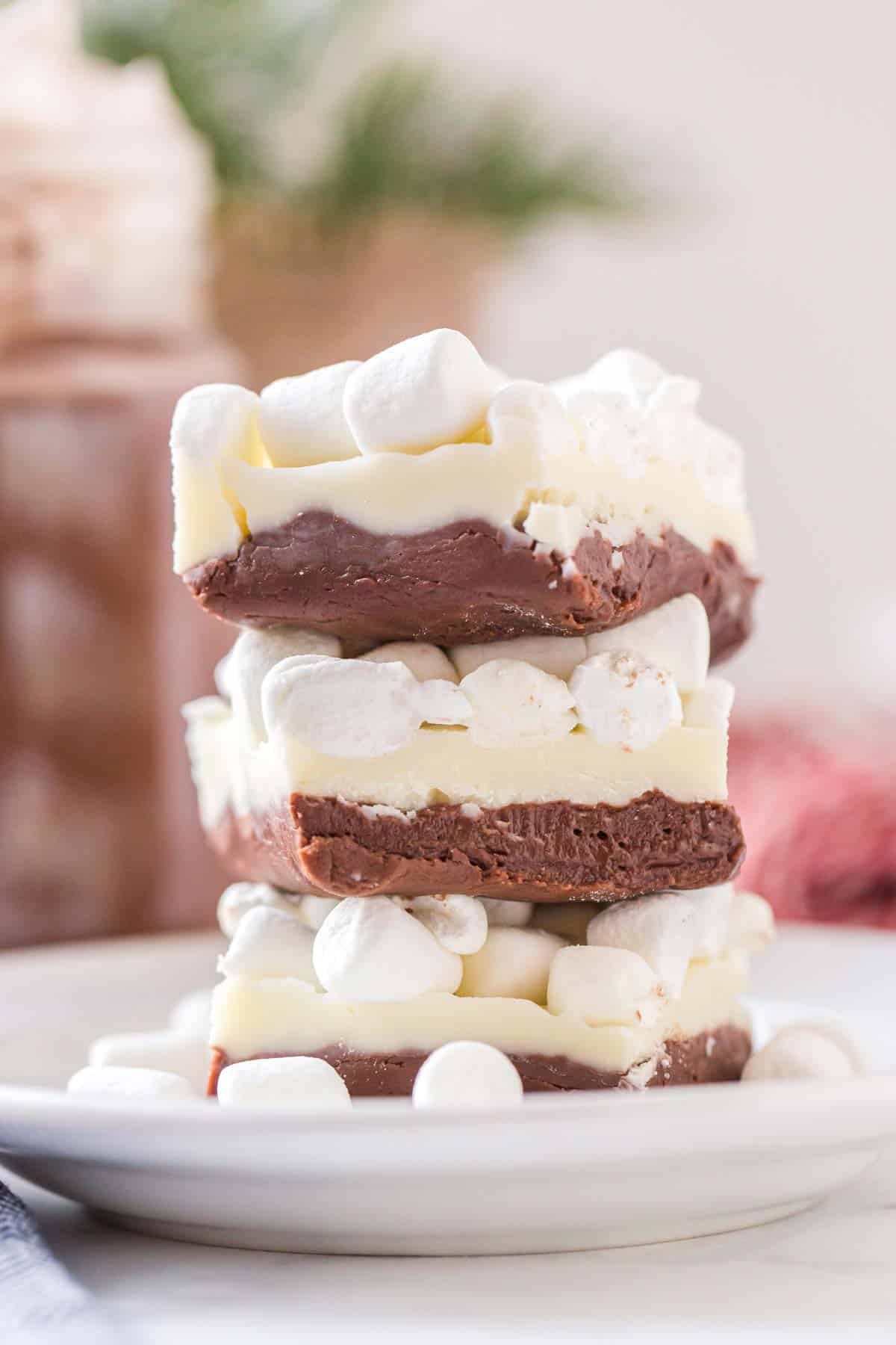 A stack of hot chocolate fudge, topped with mini marshmallows