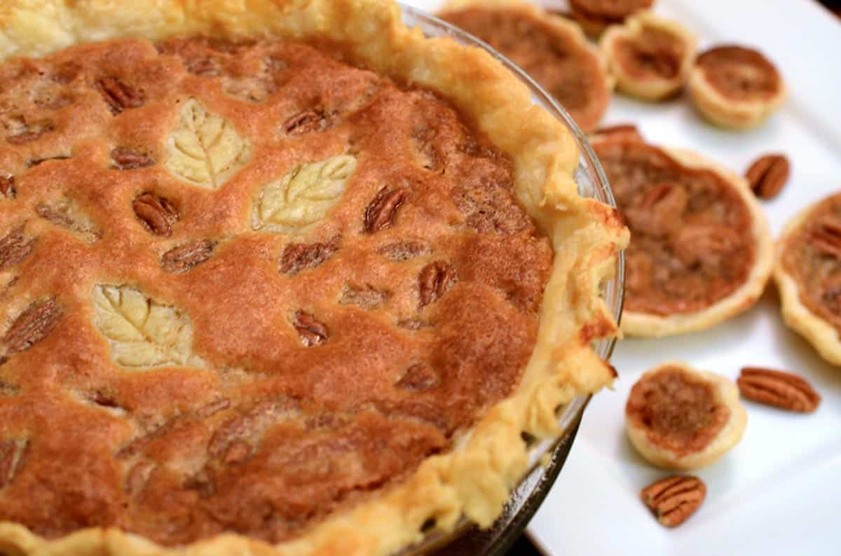 A whole pecan pie and some mini pecan pies.