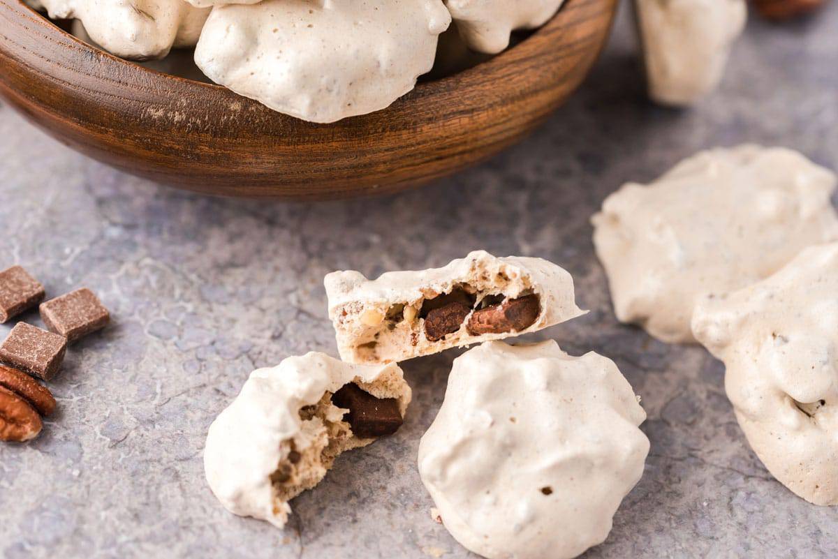 A chocolate chip meringue cookie split in half.