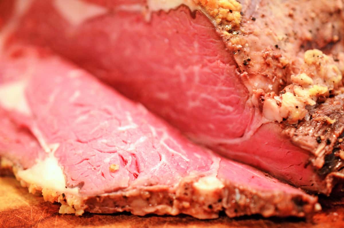 Cutting prime rib. A slice of meet on a cutting board.