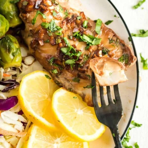 Eating a portion of haddock from a plate.