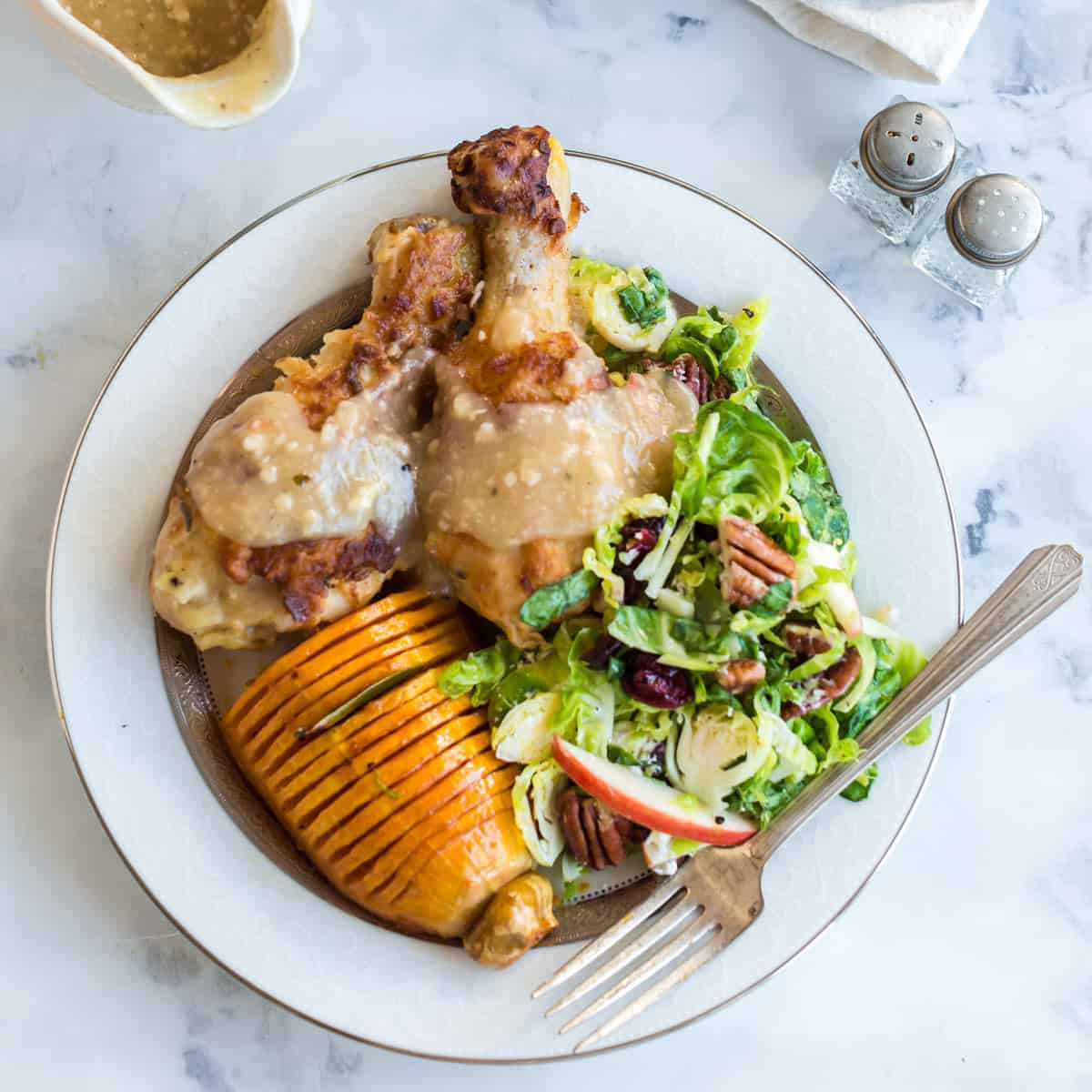 A plate of food with chicken and salad.
