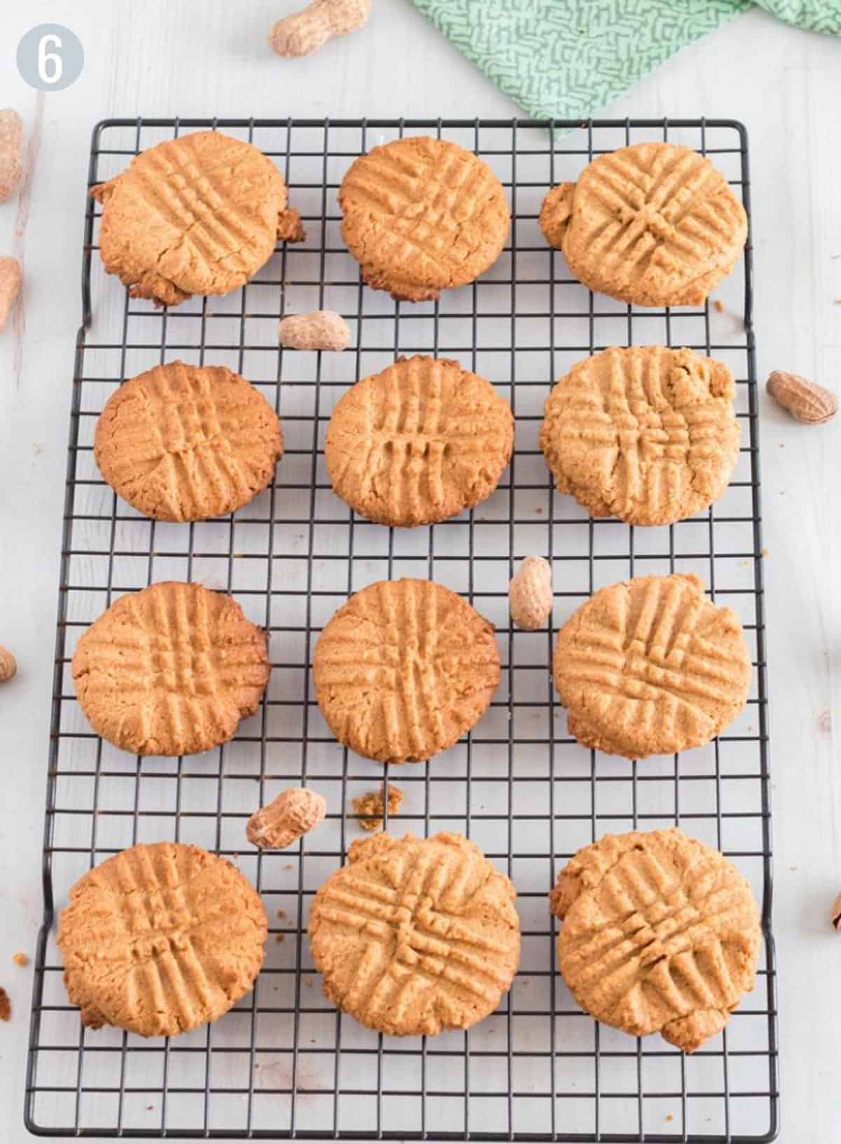 12 peanut butter cookies on a cooling rack.