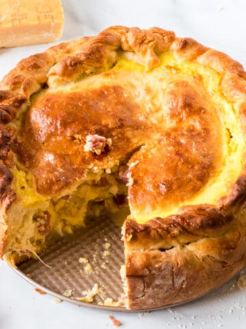 A fresh-baked Italian Easter pie with a slice cut out.