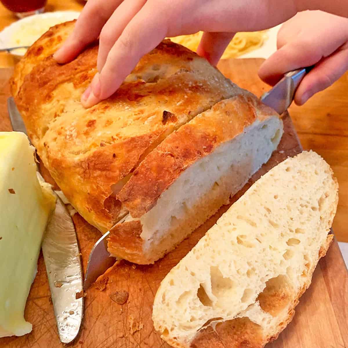Slicing a loaf of crusty bread.