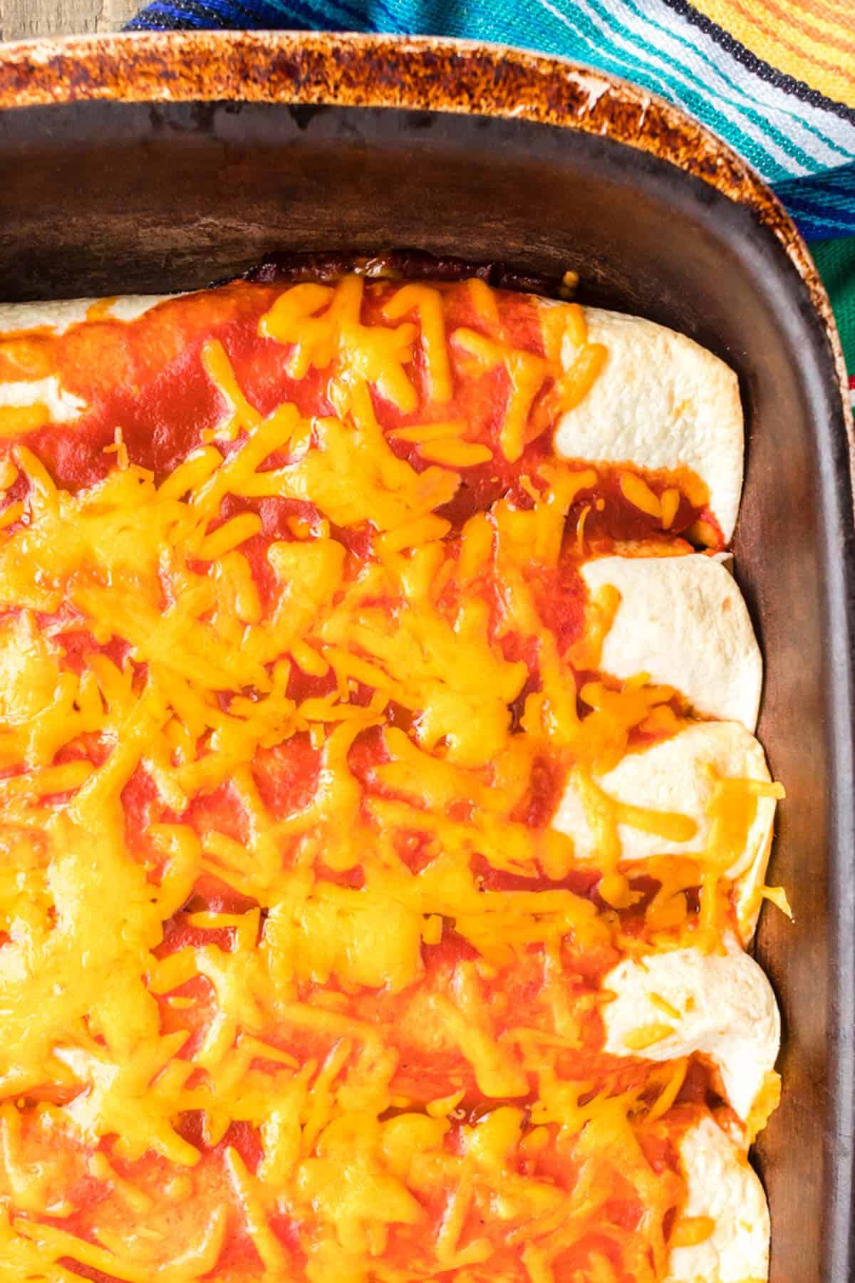 A pan of food with cheese on top.