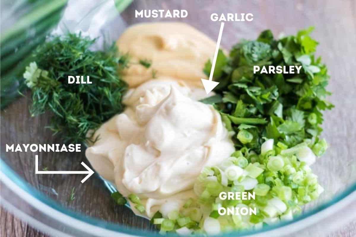 Ingredients for chicken salad in a mixing bowl.