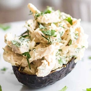 An avocado stuffed with chicken salad.