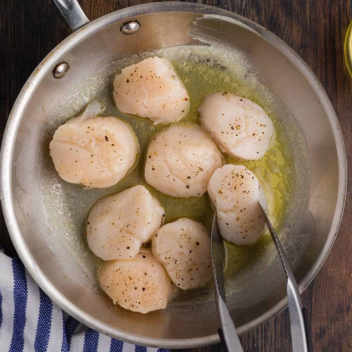 A bunch of food sitting in a pan with oil and butter.