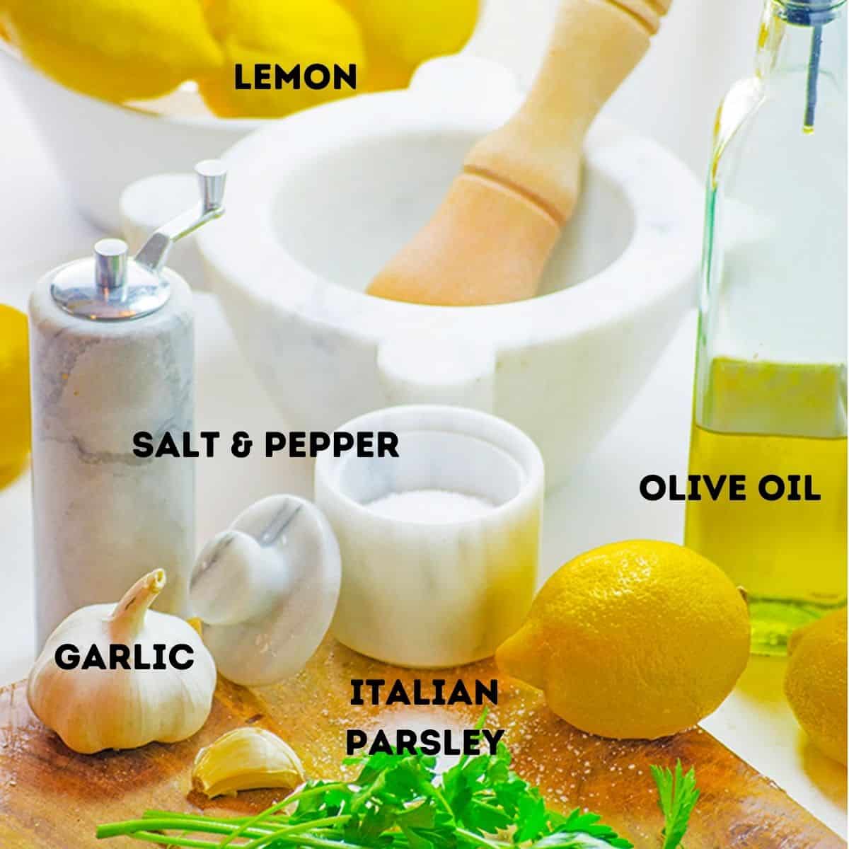 Lemon, olive oil, garlic, and other ingredients to marinate shrimp.