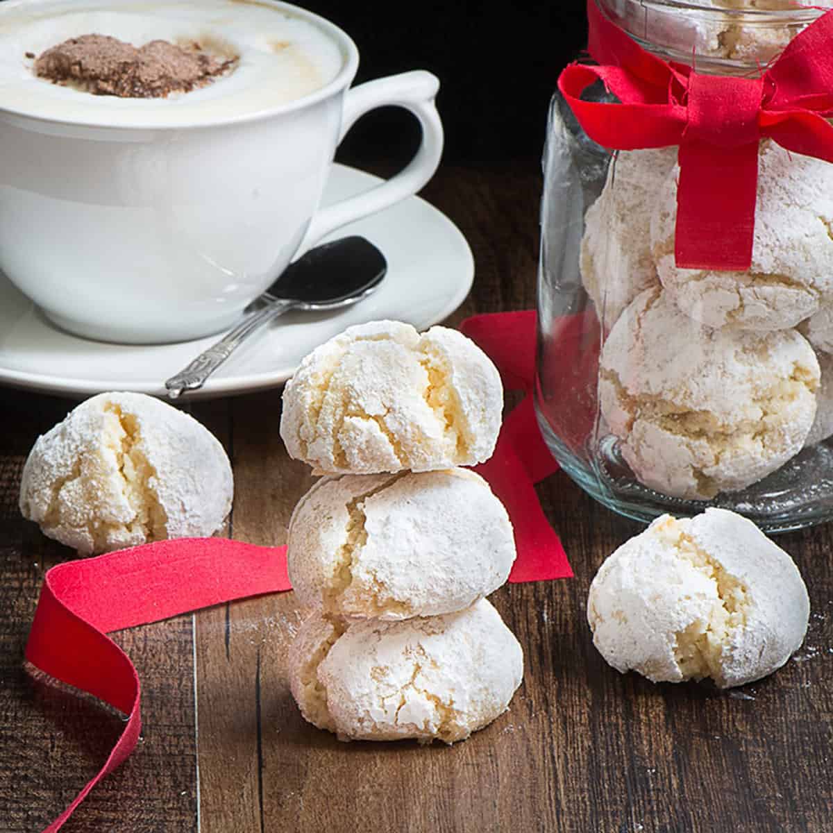 A stack of amaretti biscuits with hot chocolate.