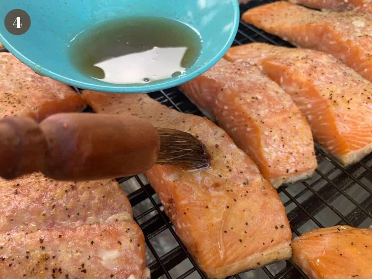 Brushing smoked salmon with pure maple syrup.