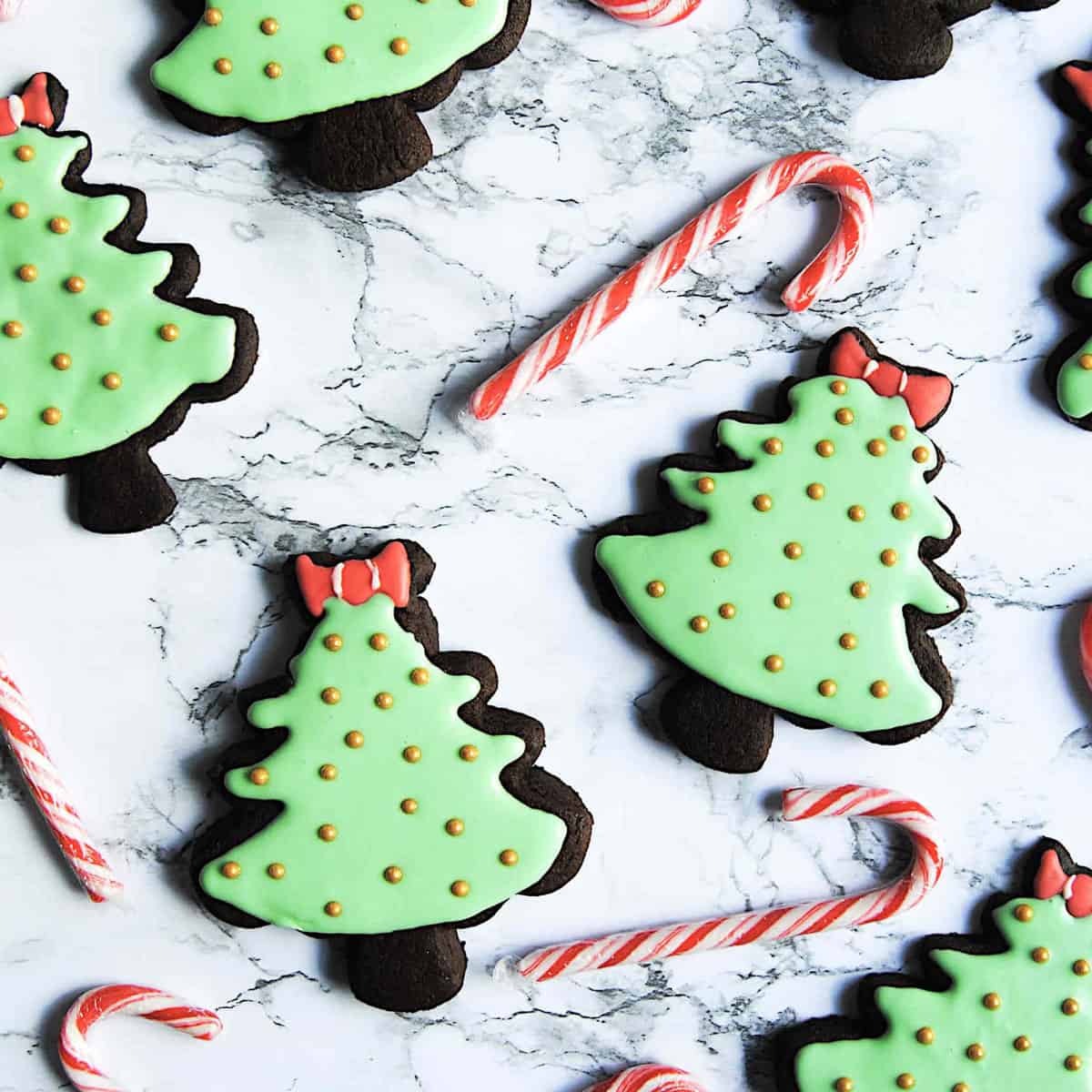 A group of Christmas cookies with candy canes.
