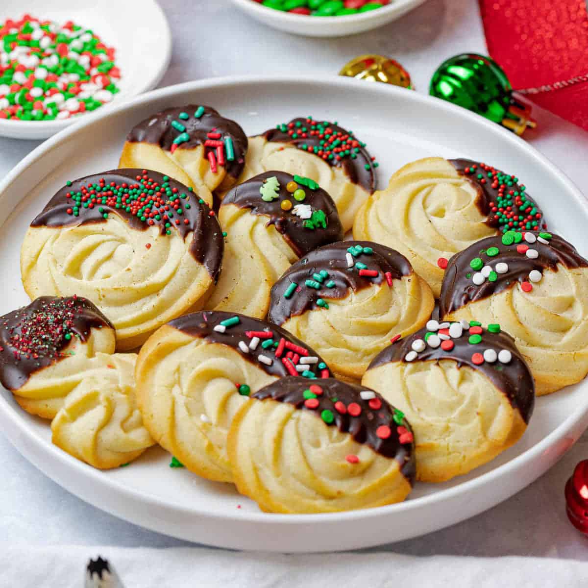 A plate of Christmas cookies dipped in chocolate.