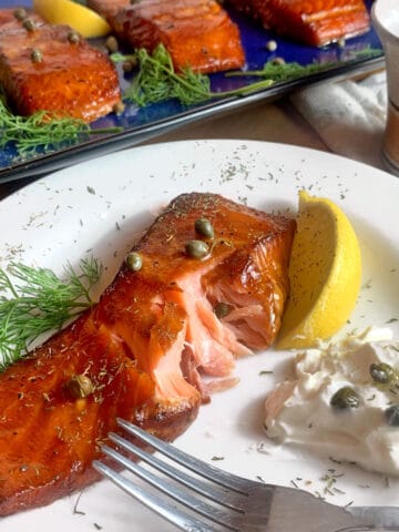 A plate of smoked salmon with cream cheese and capers.