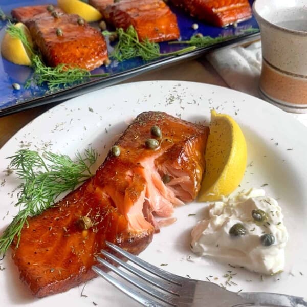 A plate of smoked salmon with cream cheese and capers.