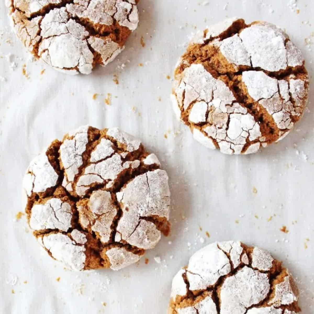 A group of crinkle cookies on a baking sheet.