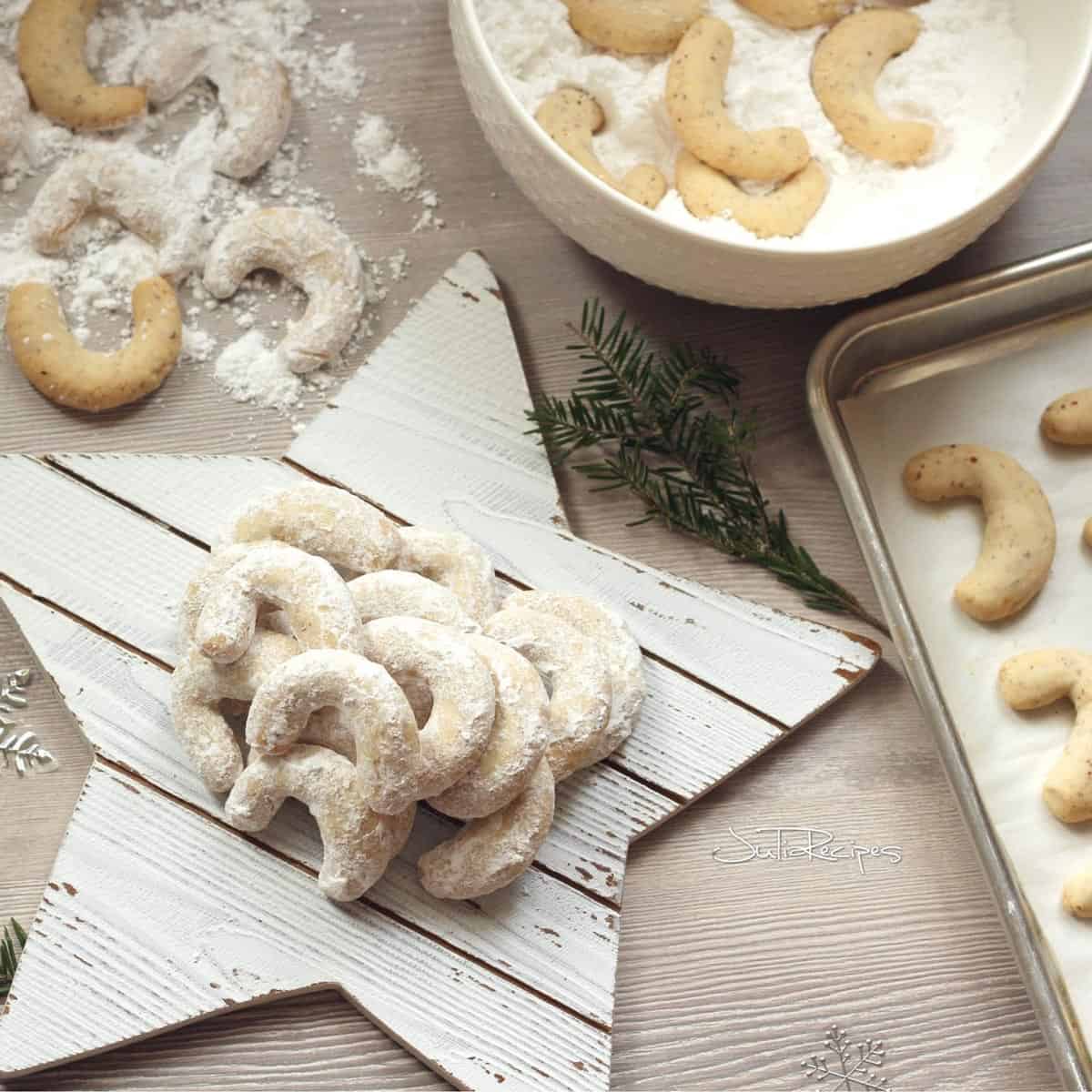 A bunch of crescent-shaped cookies being made.