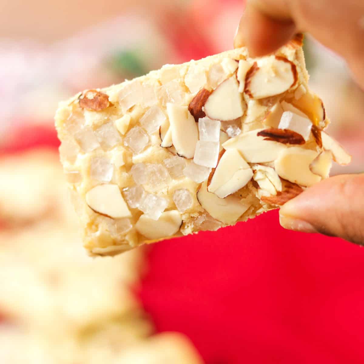 A dessert bar with nut slivers on top.