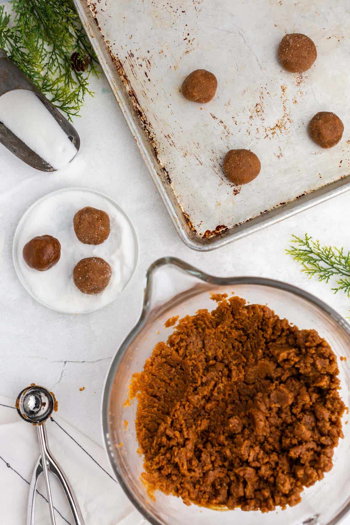 a bowl of cookie dough and a cookie scoop.