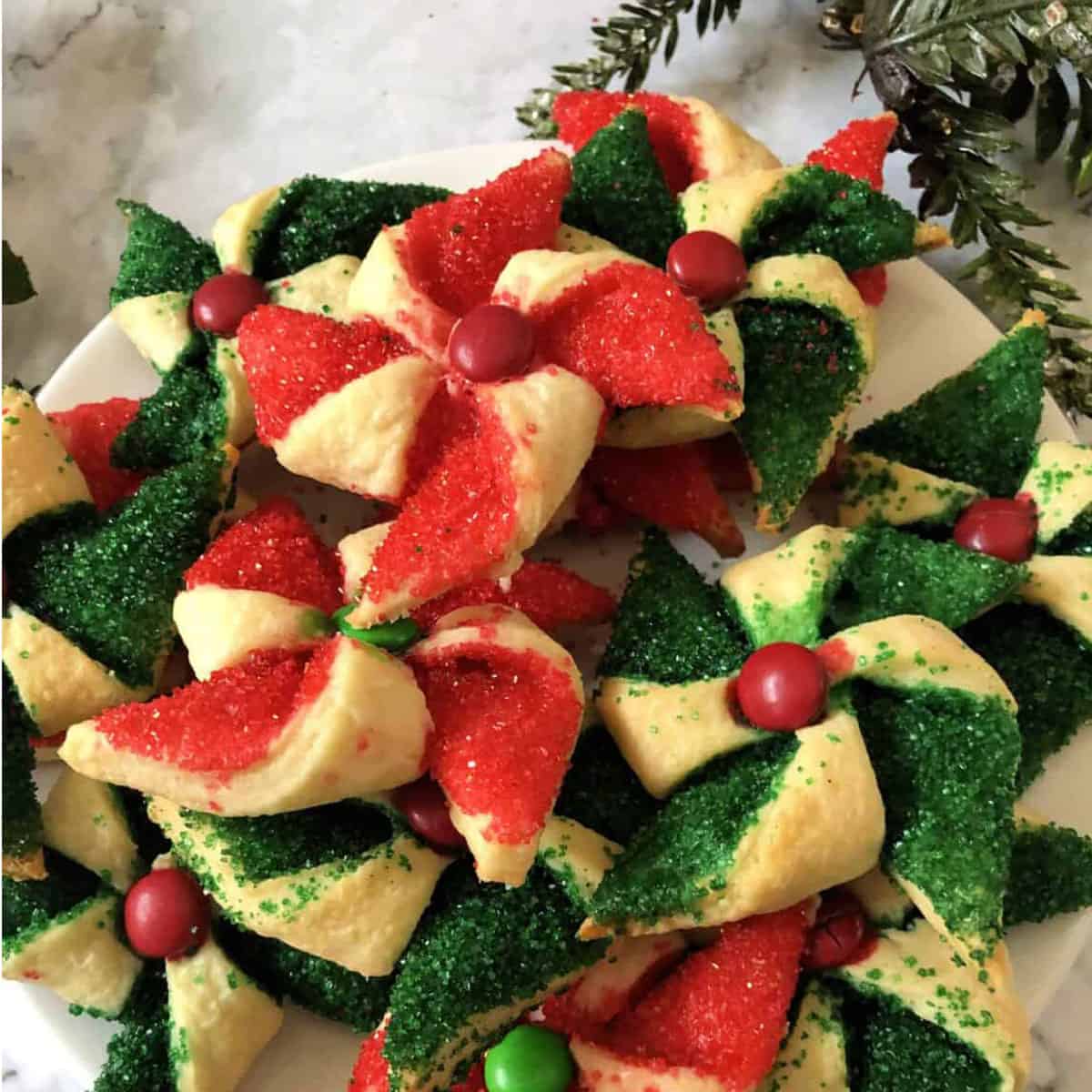 A bunch of Christmas cookies that look like poinsettias.