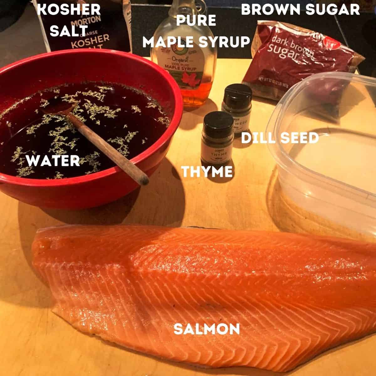 Salmon and other ingredients on a cutting board.