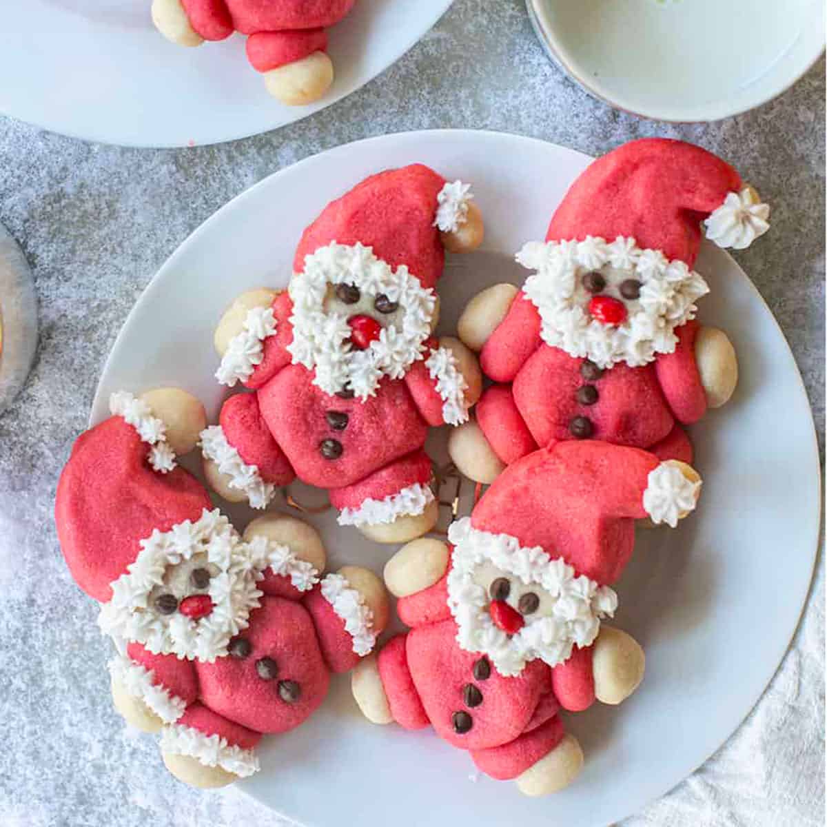 A plate of cookies shaped like Santa Claus.