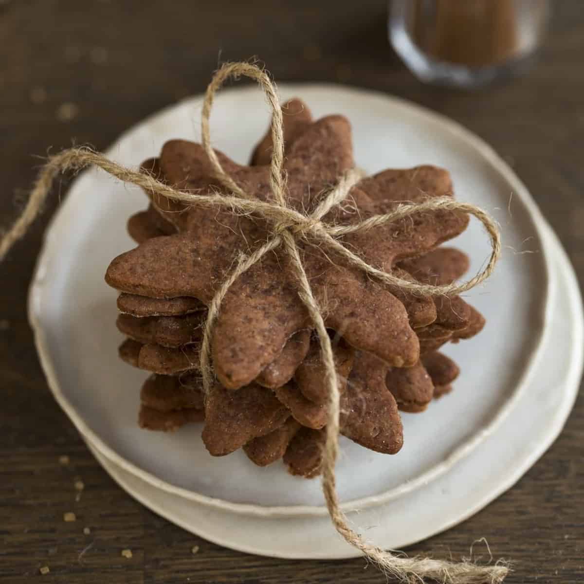 A stack of brown snowflake-shaped cookies tied by twine.