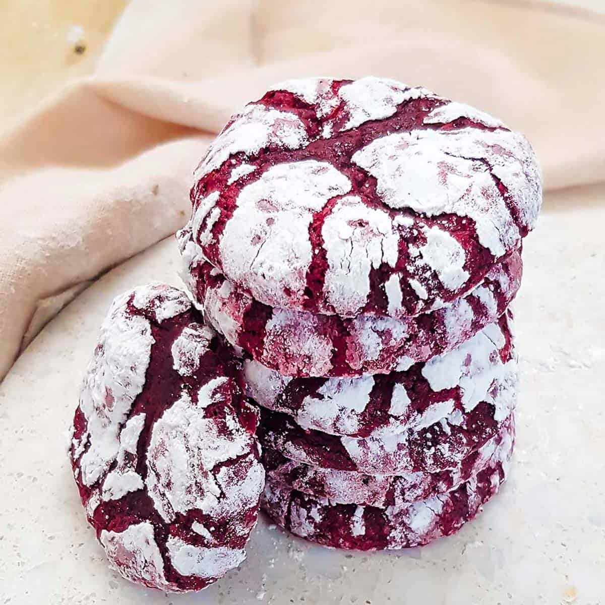 a stack of red velvet crinkle cookies.