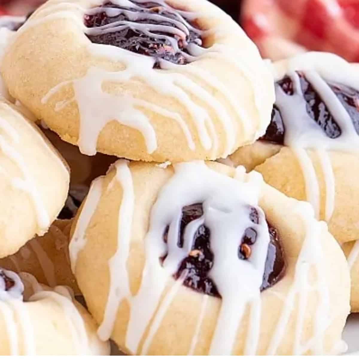 A stack of thumbprint cookies with vanilla glaze.